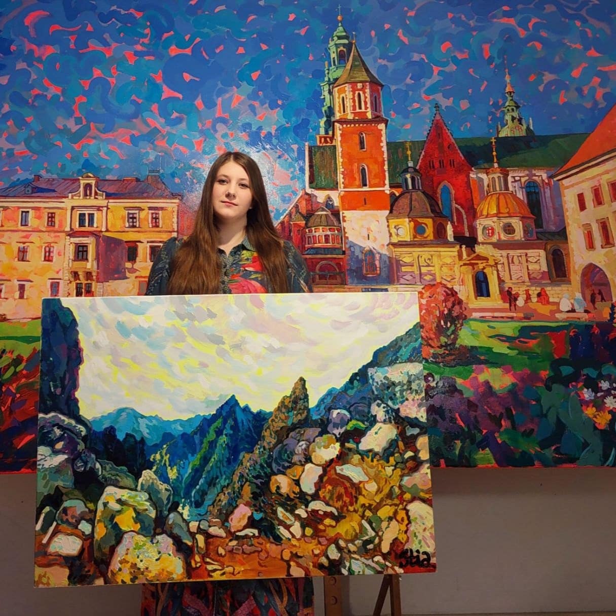 Hello, I'm STIA.I'm Anastasiia Kurkova, a Ukrainian painter and the creator of Emochromism.For me, color is more than something we see. It is a way of understanding the world. It is the ability to encounter the world as if it were still new.
Every painting begins with a real experience, but it becomes something more than a landscape or a city. It becomes an expression of my belief that the world remains worthy of attention, admiration, and discovery.The painting I'm holding has already found its new home. The one behind me is still part of my journey.Thank you for being here.Wonder is not naïveté.